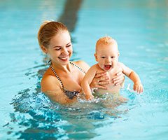 Mother and baby in pool