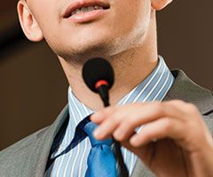 Public speaker with microphone