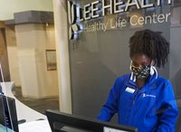 A Healthy Life Center employee manning the front desk