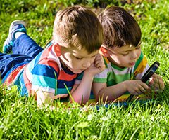 Two boys playing in grass