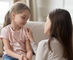 Woman comforting child patient