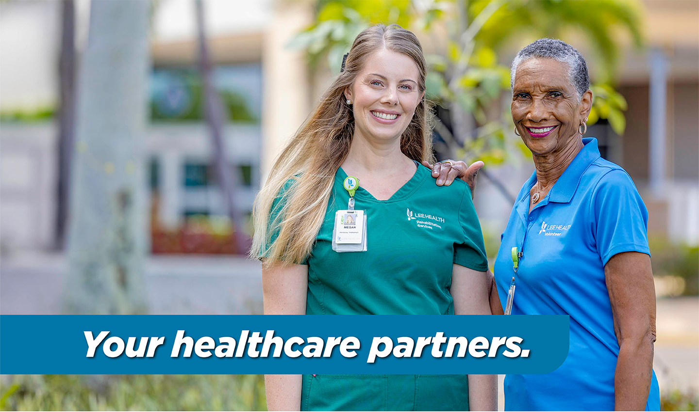 Two women standing outside of Lee Health hospital