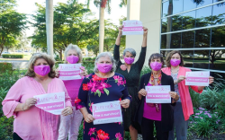 Women holding I'm a Survivor Signs 